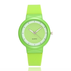 Minimalist quartz sports watch with lime green silicone strap and round dial face