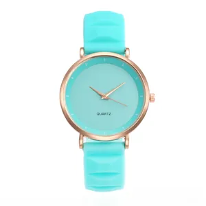 Detailed macro view of mint green silicone strap and rose gold metal watch case