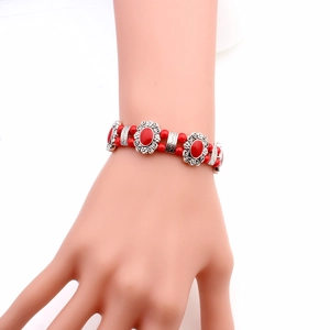 Ethnic style red bead bracelet with vintage silver filigree details on a wrist