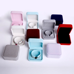 Detailed view of velvet jewelry gift boxes in multiple colors with square lids and soft lining