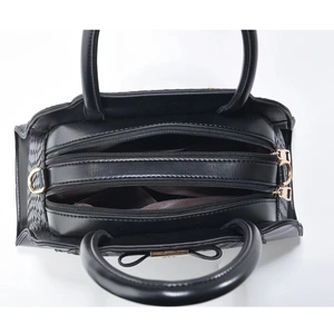 Internal view of black PU tote bag showing three separate zipper compartments and lining