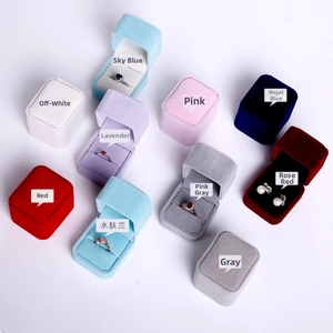 Flat lay of colorful velvet jewelry boxes for rings and earrings in multiple colors