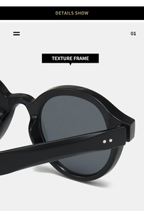 Detail shot of the thick black oval frame sunglasses with silver rivet accents
