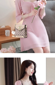 Close-up of beige leather mini crossbody bag with golden swan buckle and cloud charm