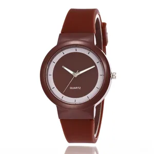 Detail of a brown quartz sports watch featuring a flexible silicone band and a minimal dial