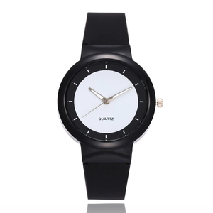 Minimalist black and white quartz sports watch with a matte silicone strap on white background