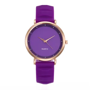 Detail of slim purple silicone watch strap with geometric texture and rose gold case