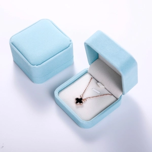 Detail view of two sky blue velvet jewelry boxes, showing both open and closed styles