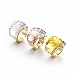 Three-piece set of gold-tone metal rings with large colorful faceted glass crystals