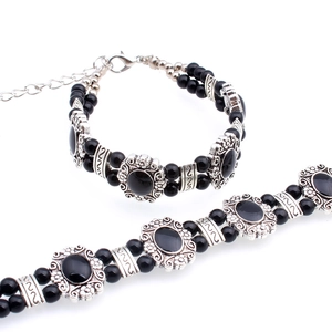 Bohemian silver bracelet set with black resin gemstones and intricate floral engravings