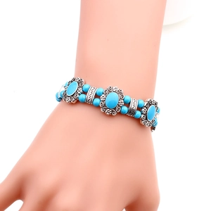 Detail of bohemian turquoise beads and engraved silver pieces on a vintage bracelet