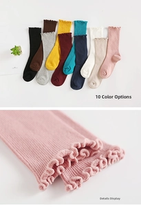 Macro detail of ribbed cotton socks with ruffled edges in ten various colors