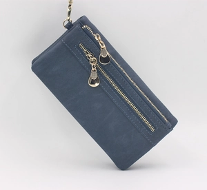 Detail of blue long wallet with dual golden zippers and metallic hanging hook