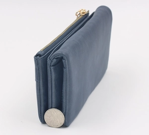 Side view of dark blue matte leather long wallet showing multi-layered gusset structure