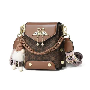 Detailed view of brown printed phone bag with 17x10x17cm size specs and gold swan buckle
