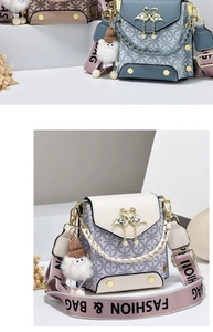 Close-up of stylish crossbody bags with circular pattern and swan metal clasp detail