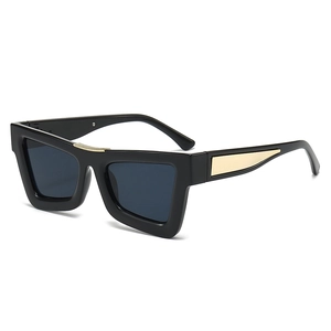 Modern cat-eye sunglasses with thick black frames and golden wheat ear metal accents