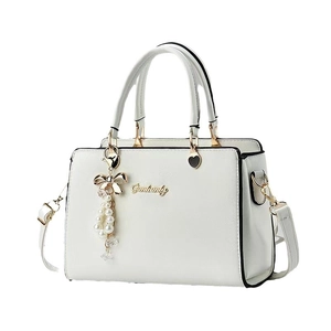 White faux leather crossbody bag with top handles, gold logo, and pearl bow charms