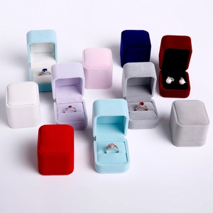 Array of colorful velvet jewelry boxes for rings and earrings in various elegant shades