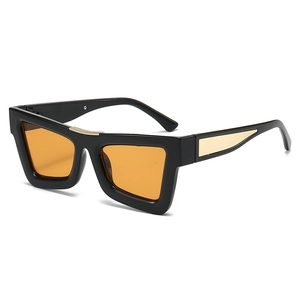 Chic black frame cat eye sunglasses with orange lenses and gold wing-shaped metal temple detail