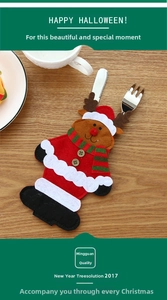 Close-up of reindeer felt cutlery holder with striped scarf on a festive wooden table