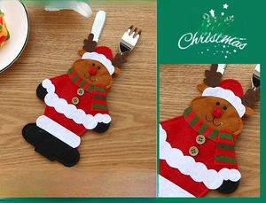 Detailed view of reindeer shaped Christmas cutlery holders on a natural wooden table