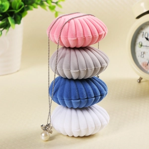 Flocked shell jewelry box organizer in pink, blue, white, and grey with velvet texture