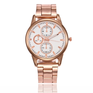 Detail of rose gold watch with white chronograph dial and metal link bracelet on white base