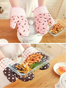 Detailed view of thick floral and plaid oven mitts for heat resistant kitchen use