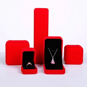 Macro shot of red velvet jewelry boxes with black lining for rings and necklaces