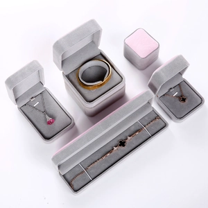 Macro shot of assorted dusty pink velvet jewelry boxes for necklaces and bracelets on white