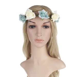 Detail of blue and white velvet rose flower headband with realistic green leaf accents