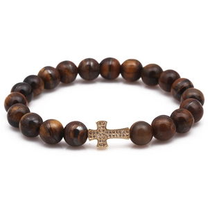 Tiger eye bead bracelet with gold plated zircon cross pendant on a white background
