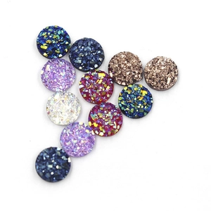 Macro view of 8mm round resin druzy cabochons with colorful glitter in V-shape layout