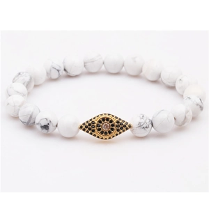 Elastic beaded bracelet with white howlite stones and golden evil eye charm with cubic zirconia