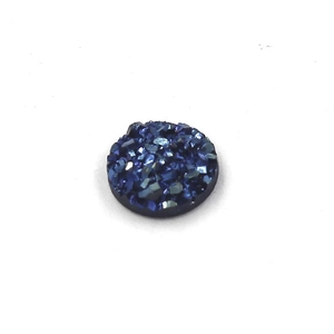 Macro detail of 8mm deep blue resin cabochon with star-like crushed crystal texture