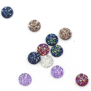 Close-up of 8mm round resin flatback rhinestones with sparkling starry textures in multi-colors
