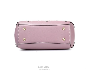 Detail view of the lavender pebble leather bag base with four protective gold metal studs