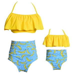 Detail of matching mother and daughter bikini set with yellow ruffles and banana prints
