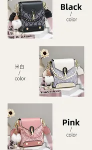 Detail view of small crossbody bag with woven chain, fuzzy pendant, and nylon strap