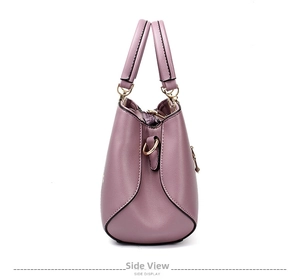 Side view of lavender faux leather shoulder bag with pebbled texture and gold hardware