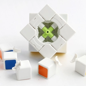 Disassembled white 3x3 magic cube showing internal green core and components