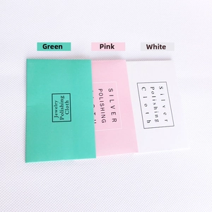 Flat lay of pink, green and white jewelry polishing cloth envelopes with black frames