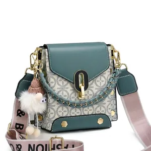 Detailed view of vintage monogram saddle bags in green and blue with fashion strap