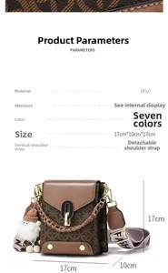 Detail view of small square crossbody bag with vintage pattern and gold chain strap