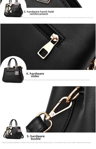 Detail of gold-tone hardware on black lychee grain leather handbag with reinforced handle