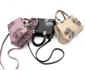Detailed embroidery of ginkgo leaves on PU leather handbags in purple, black, and beige