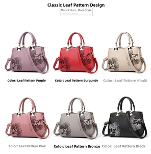 Six leaf-patterned handbags in various colors with clover pendants and gold hardware