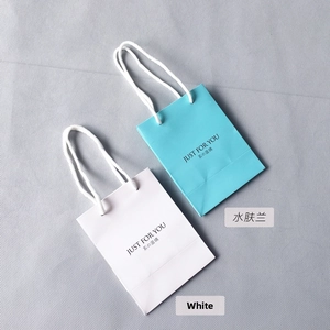 Small white and light blue paper gift bags with Just For You text and cotton rope handles