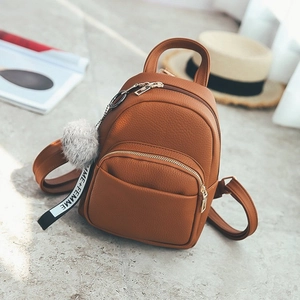 Mini brown faux leather backpack with a grey pompom charm and stylish ribbon detail